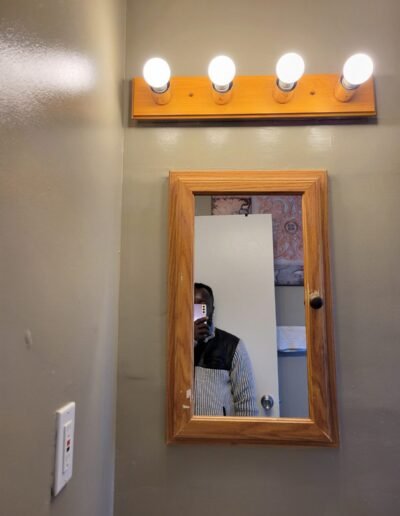 Vanity light fixture installed above a bathroom mirror in Seat Pleasant, MD