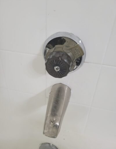 Bathtub faucet handle and spout before repair in Bowie, MD