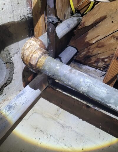 Corroded drain pipe in a basement before repair in Washington, DC