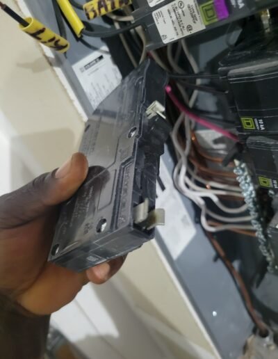 Electrician installing a new breaker in an electrical panel in Crofton, MD