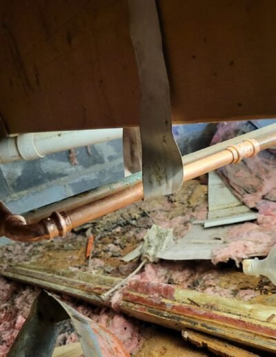 Copper water pipe under a floor during leak repair in Glenarden, MD