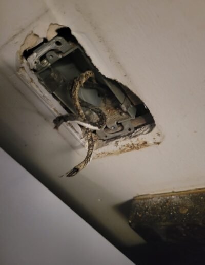 Damaged electrical outlet box before repair in Washington, DC