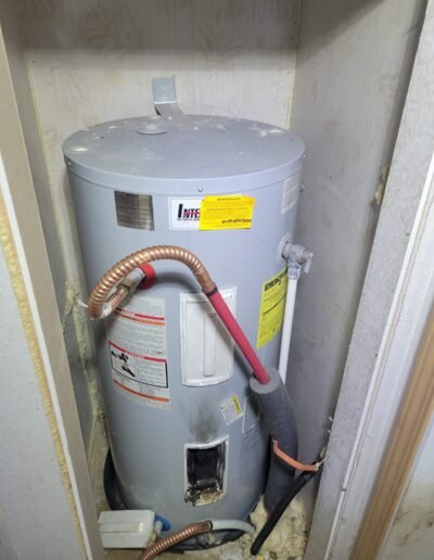 Electric water heater before replacement in Dunkirk, MD
