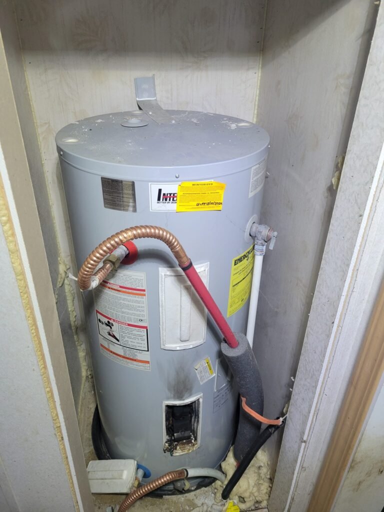 Electric water heater before replacement in Dunkirk, MD