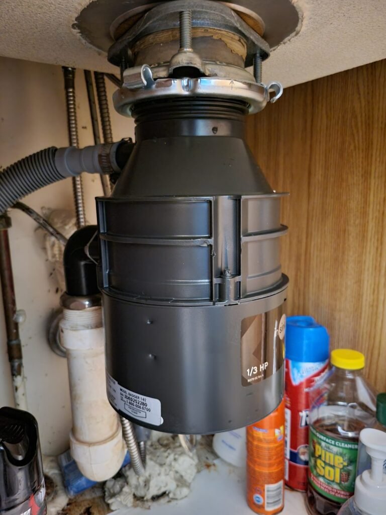 New garbage disposal installed under a kitchen sink in Laurel, MD