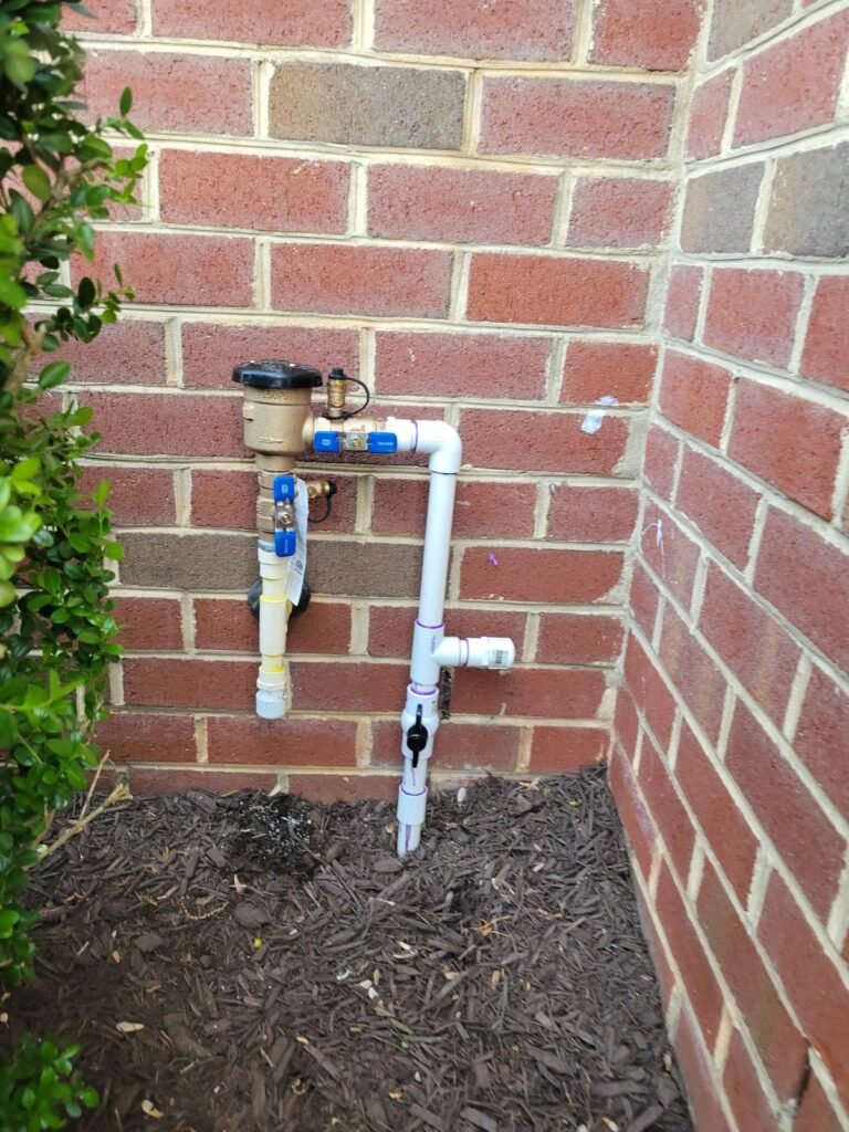 Backflow preventer installed against a brick wall in Severn, MD