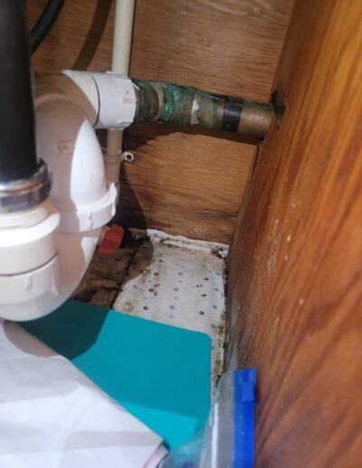 Kitchen sink drain plumbing under a cabinet in Washington, DC