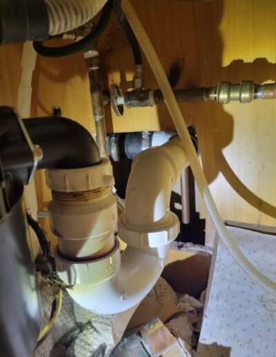 Kitchen sink drain and trap under a cabinet in Washington, DC