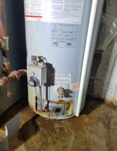 Leaking water heater with rust at the base in Seat Pleasant, MD