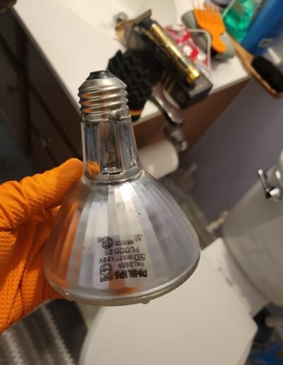 Electrician replacing a recessed light bulb in Woodbridge, VA