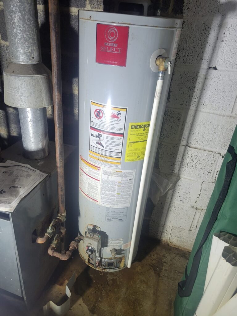 Aging gas water heater with rusted fittings before replacement in a Seat Pleasant, MD basement