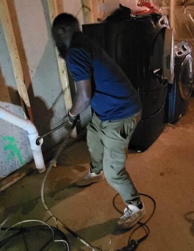 Plumber clearing a clogged drain line in Upper Marlboro, MD
