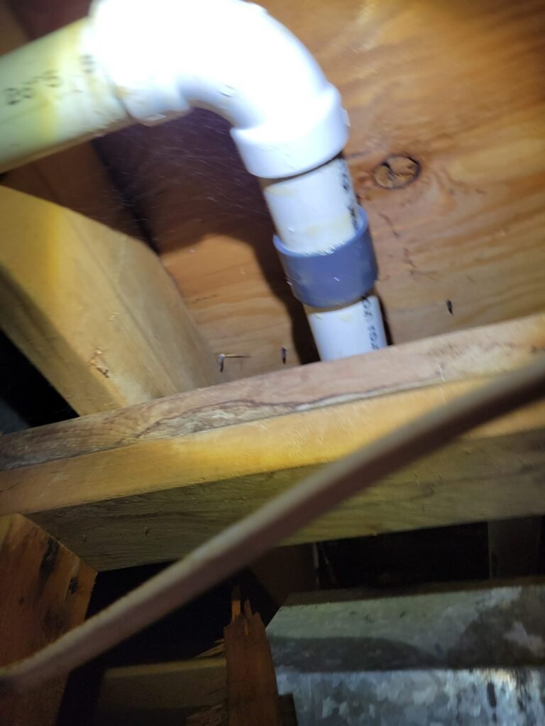 PVC drain line connection under floor joists in Woodbridge, VA