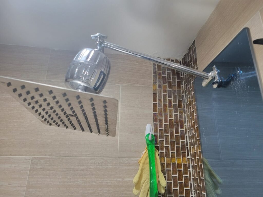New square rain shower head installed in a tiled shower in Gaithersburg, MD