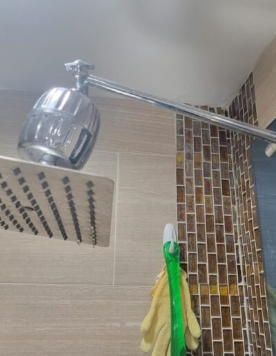 New square rain shower head installed in a tiled shower in Gaithersburg, MD
